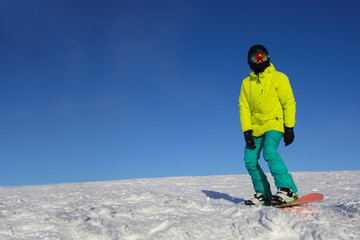 Fototapeta na wymiar Snowboarder riding on slope