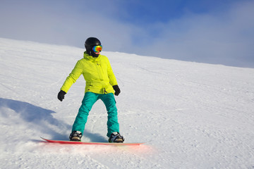 Snowboarder riding on slope