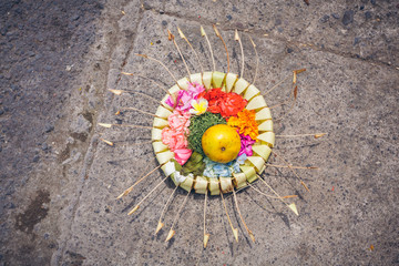 Floral offerings in straw baskets for Hindu spirits and gods for religious reasons in Ubud, Bali,...