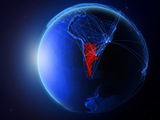 Argentina from space on planet Earth with blue digital network representing international communication, technology and travel.