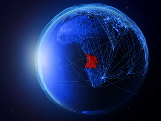 Angola from space on planet Earth with blue digital network representing international communication, technology and travel.