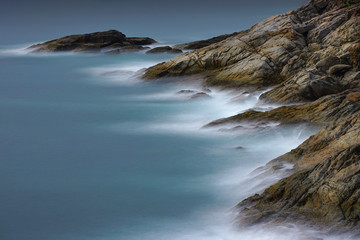 Water wave splashes and rock at Promthep cape located in Rawai, Phuket, Thailand. 
