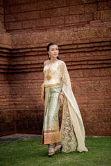 Naklejka premium Beautiful Woman wearing typical Thai dress