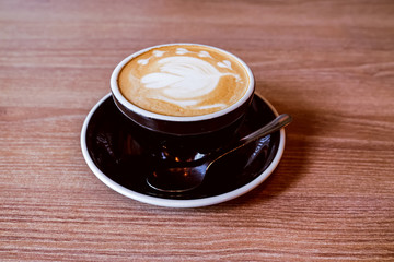Hot Latte Coffee on wooden floor