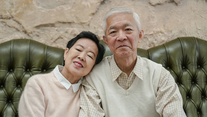 Wealthy Asian elderly couple happy in luxury house