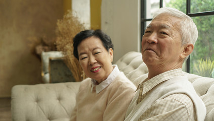 Wealthy Asian elderly couple happy in luxury house