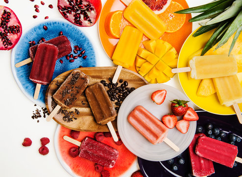 colorful assorted popsicles with fruit and ingredients