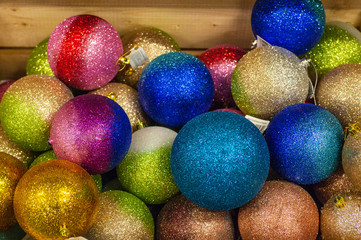 Sale of Christmas toys in the supermarket. Balls of different colors for the Christmas tree on the supermarket shelves. 