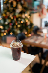 ice black coffee and splash bokeh lighting in christmas holidays