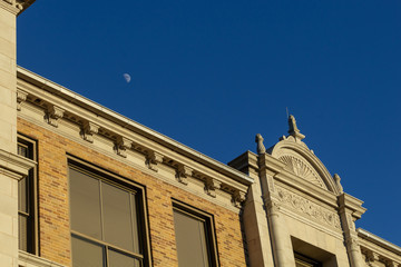 Fototapeta na wymiar moon above facade of building