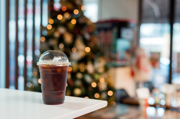 ice black coffee and splash bokeh lighting in christmas holidays