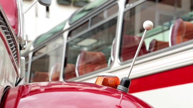 Slider shot of details on 2 oldtimer bus coaches.