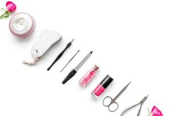 manicure equipment with nail polish and rose petals white background top view space for text