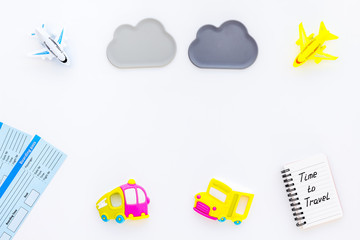 planning trip with child with toys, notebook and tickets white background top view space for text. Time to travel.