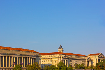 Fototapeta premium Historic architecture of Washington DC along the National Mall in summer. Buildings with columns with elaborate finishing and roofs.
