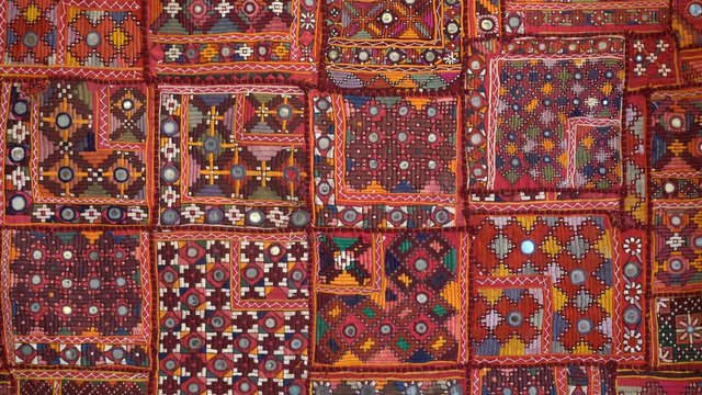 Detail old colorful patchwork carpet, establishing shot. Close up