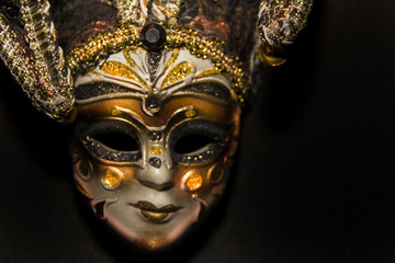 masks and feathers of venice carnival on black background