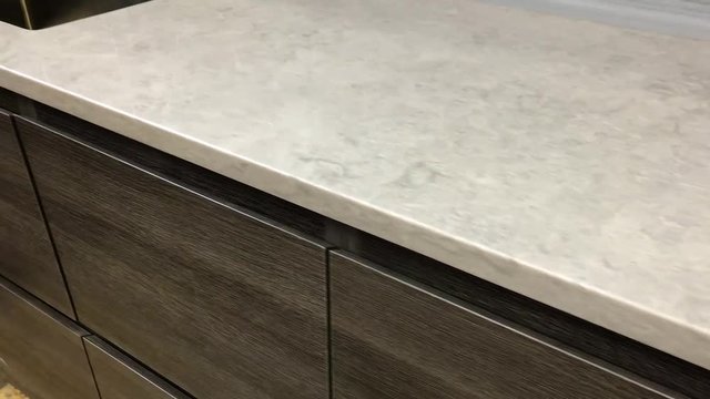 Modern granite kitchen countertops with full backsplash and brown wood kitchen cabinets
