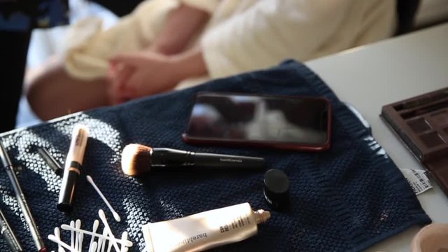 Make up artist with female model