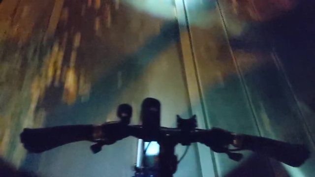 peron riding his bike through the pown, camera down to the handlebar point of view