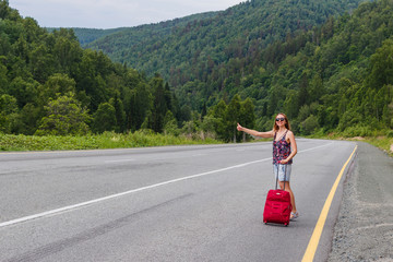 young woman hitchhiking. to catch the car