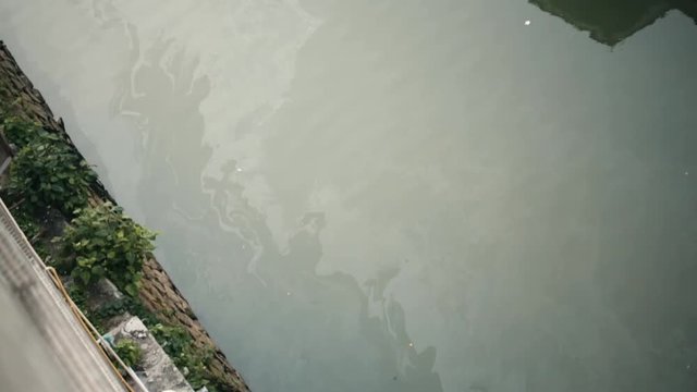 Poisoned dirty river slow motion. Thailand city dirty smelly canalization