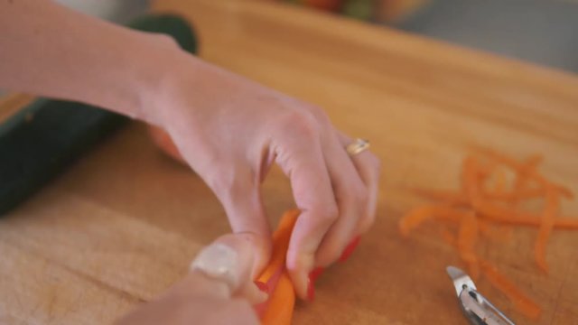 beautiful lady with red nails cutting vegetables
