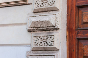 Fototapeta na wymiar Fragment of decoration on the facade of an old building, Catania, Sicily, Italy