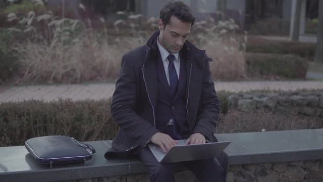 Man is actively working in a laptop