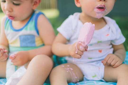 An asian little boy eating ice cream on a hot summer day. 