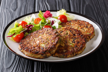Dietary mushroom patties and delicious fresh salad close-up on a plate. horizontal