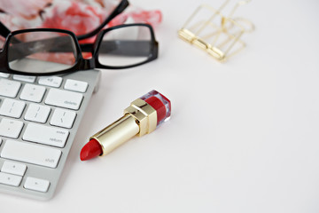 white keyboard with black glasses in white desk