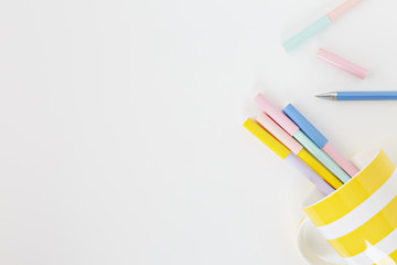 keyboard with coloured pens in white background