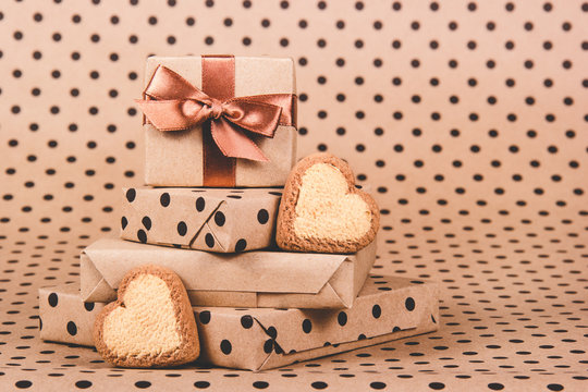 Stack of gifts and cookies hearts. Gift boxes. Festive decorations. Heart shaped cookies