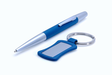 Silver-blue metal pen and keychain isolated on white