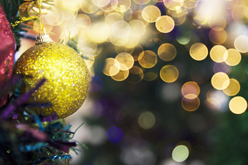 Golden shiny glittering ball on Christmas tree.