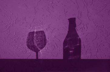 Wine bottle and glass shadow in purple tone.