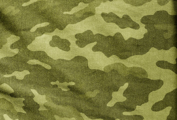 Old camouflage cloth in yellow tone.
