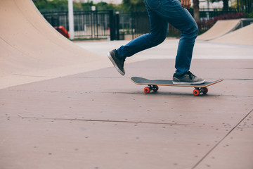 skater legs skating on ramp at skatepark