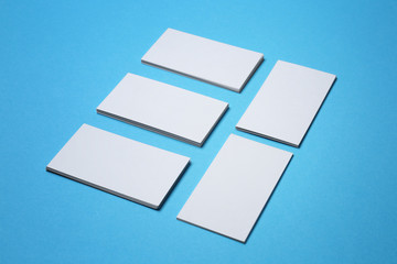 Blank business cards on color background