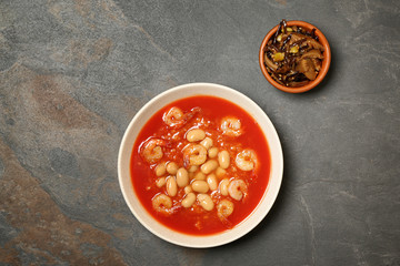 Tasty Chinese soup on grey table