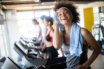 Group of healthy fit people at the gym exercising