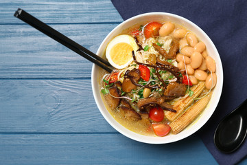 Tasty Chinese soup on wooden table