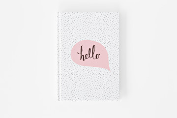 white notebook with sticker on white background