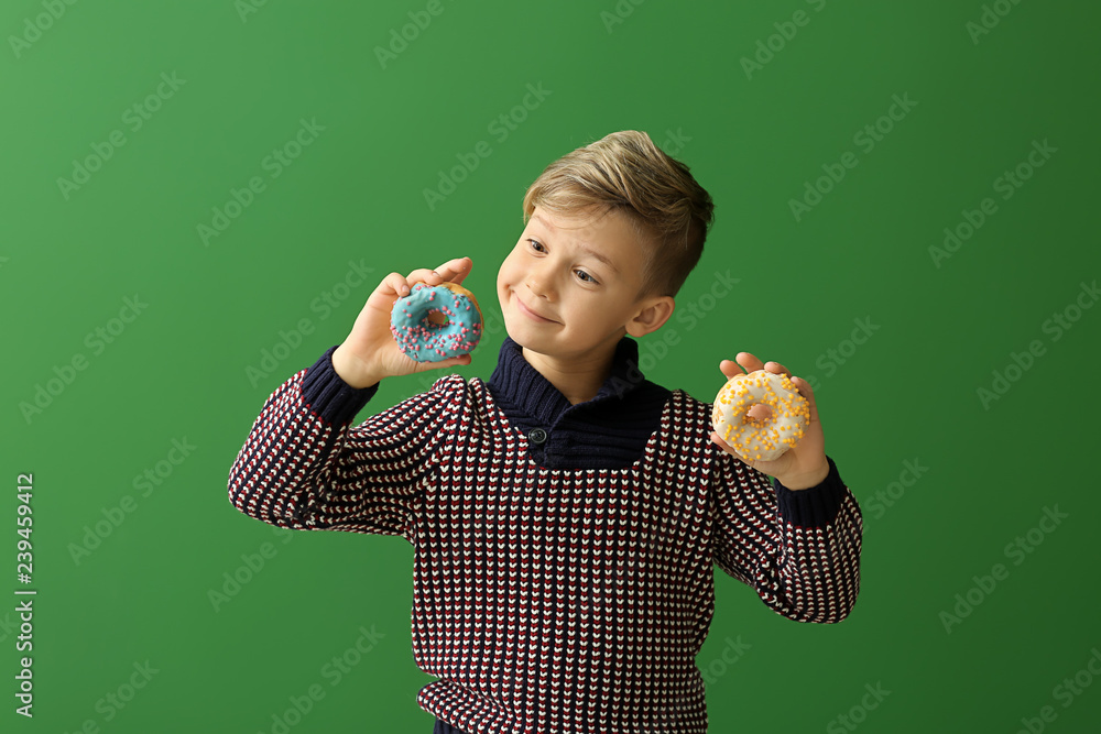 Sticker cute little boy with donuts on color background