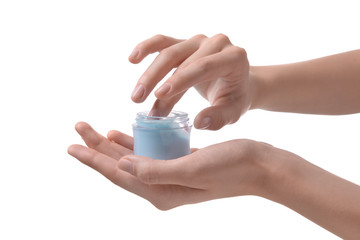 Female hands with jar of cream on white background