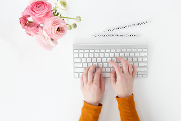 women typing on keyboard