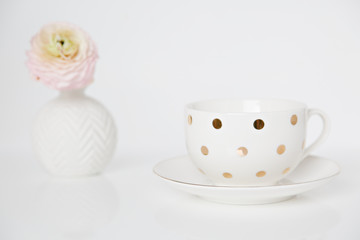 tea cup with flower on white background