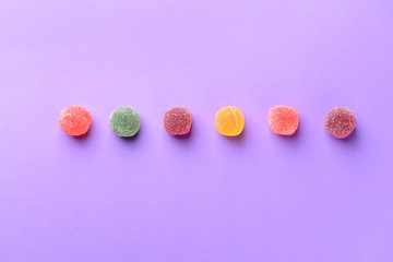 Obraz na płótnie Canvas Tasty sweet marmalade candies on color background