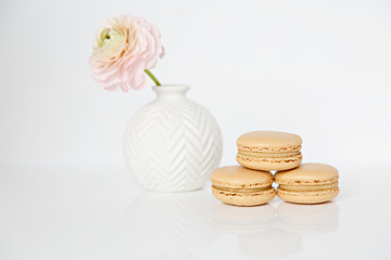 three macarons and vase of flowers